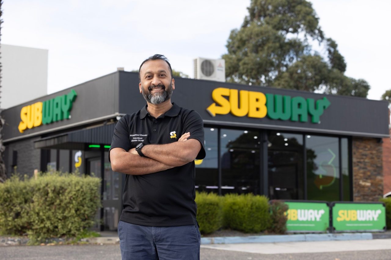 Man standing out the front of Subway